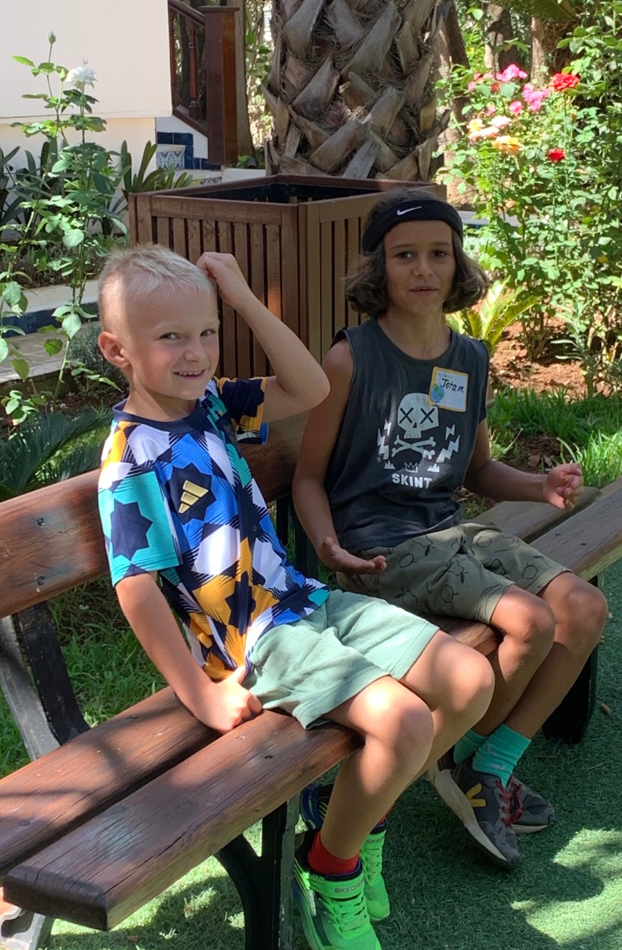 Two kids sitting on a bench